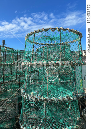 A catch box fishing trap is drying on the shore in the port. 131453772