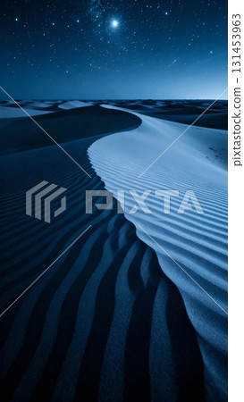 Wind patterns in the indigo desert dunes under a starry sky 131453963