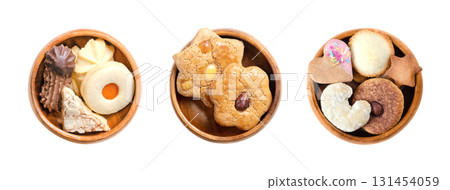 Variety of Christmas cookies and biscuits in wooden bowls. Traditional gingerbread and butter cookies, in different shapes, filled with jam, dipped in chocolate, and topped with nuts or sprinkles. Variety of Christmas cookies and biscuits in wooden bowls. Traditional gingerbread and butter cookies, in different shapes, filled with jam, dipped in chocolate, and topped with nuts or sprinkles. 131454059