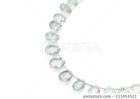 Moss aquamarine faceted drop cuts arranged on a white background 131454321