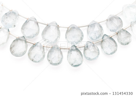 Moss aquamarine faceted drop cuts arranged on a white background 131454330