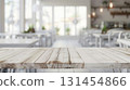 Light cafe mock up, whtie wooden table close up in the front, blurred bokeh interior background in the back. 131454866