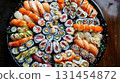 Overhead view of a vibrant sushi platter arranged, showcasing an array of colorful rolls and nigiri adorned with fresh fish, avocado, and colorful ingredients 131454872