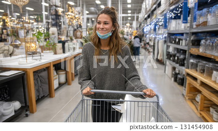 A shopper with a full cart of discounted home decor items walking through the aisles of a department store on Black Friday. Consumerism, sales, black friday. Online shopping. 131454908