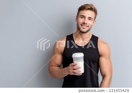 Smiling Man Holding Post-Workout Protein Shake Smiling Man Holding Post-Workout Protein Shake 131455429