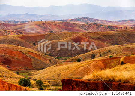 Dramatic landscape of heavily eroded red laterite hills and valleys, Befato Madagascar 131455441