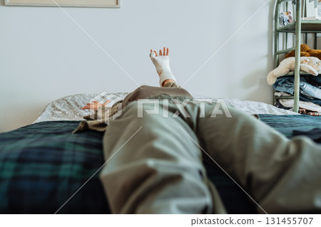 Teen girl with broken arm in bedroom Teen girl with broken arm in bedroom 131455707