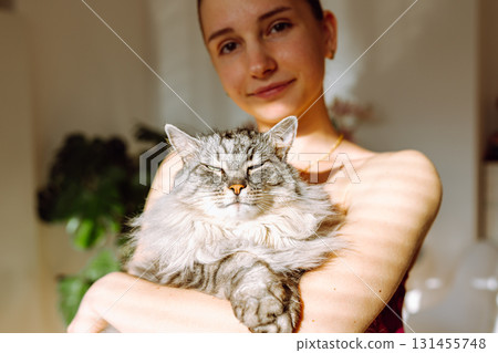 Portrait young woman with pet cat 131455748