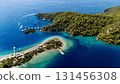 Aerial view of the Oludeniz Blue Lagoon in Fethiye, Turkey, with turquoise waters, sandy beach, forested hills, and boats, showing a popular Mediterranean travel and holiday destination. 131456308