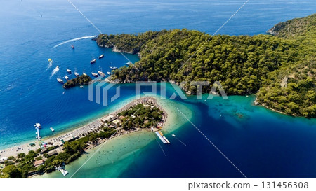 Aerial view of the Oludeniz Blue Lagoon in Fethiye, Turkey, with turquoise waters, sandy beach, forested hills, and boats, showing a popular Mediterranean travel and holiday destination. 131456308
