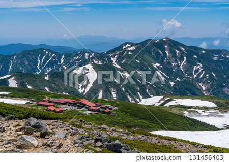 View of Mt. Betsuyama and Murodo Center from the snowy fields of Mt. Hakusan Gozenmine. Climbing Mt. Hakusan Gozenmine in early summer (Pond Tour Course) 131456403