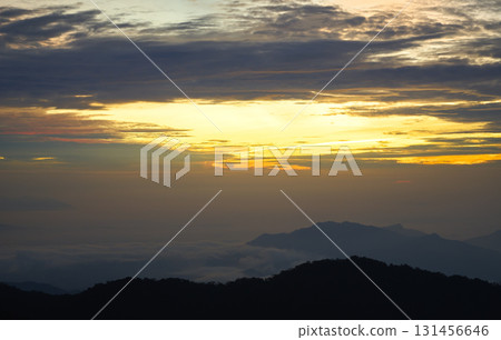 Sunrise illuminating misty mountain peaks in genting highlands, malaysia 131456646