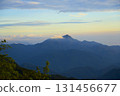 Mountain peaks with mist at sunrise highlighting nature 131456677
