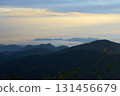 Mountain peaks rising through morning fog at sunrise 131456679