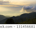 Mountains layered with mist under a golden hour sky 131456681
