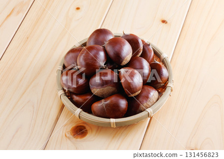 Fresh chestnuts in a colander 131456823