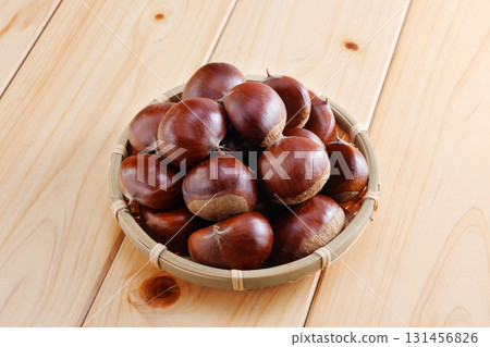 Fresh chestnuts in a colander 131456826