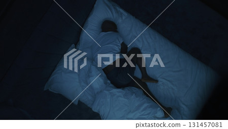 At Night, Tired Man Lies in White Bed, Moving Uneasily in Sleep Struggles With Nightmares At Night, Tired Man Lies in White Bed, Moving Uneasily in Sleep Struggles With Nightmares 131457081