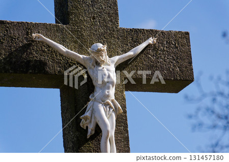 Beautiful Jesus Christ on crucifix, cemetery on a sunny day, spring, Easter, new life and religion concept Beautiful Jesus Christ on crucifix, cemetery on a sunny day, spring, Easter, new life and religion concept 131457180