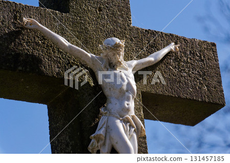 Beautiful Jesus Christ on crucifix, cemetery on a sunny day, spring, Easter, new life and religion concept Beautiful Jesus Christ on crucifix, cemetery on a sunny day, spring, Easter, new life and religion concept 131457185