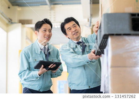 Male worker working in a warehouse Male worker working in a warehouse 131457262