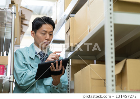 Male worker working in a warehouse Male worker working in a warehouse 131457272