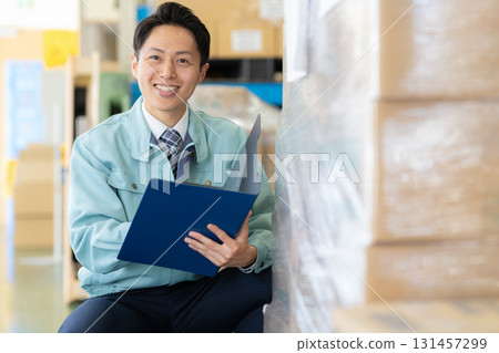 Male worker working in a warehouse Male worker working in a warehouse 131457299