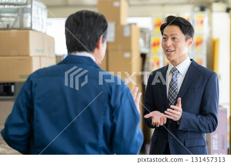 Manager and businessman negotiating in a warehouse Manager and businessman negotiating in a warehouse 131457313