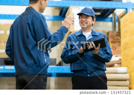 Male worker working in a warehouse Male worker working in a warehouse 131457321