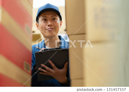 Male worker working in a warehouse Male worker working in a warehouse 131457337