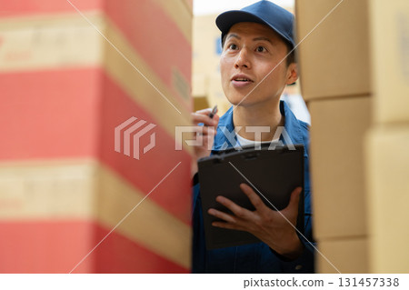 Male worker working in a warehouse Male worker working in a warehouse 131457338