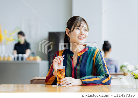 A young woman relaxing in a cafe 131457350