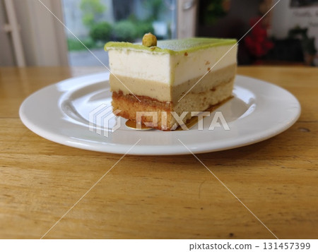 Pistachio cake on dish with layers. 131457399