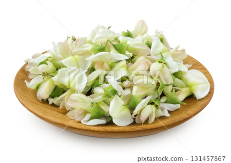 flowers of Sophora japonica or Styphnolobium japonicum in wooden bowl isolated on white background flowers of Sophora japonica or Styphnolobium japonicum in wooden bowl isolated on white background 131457867