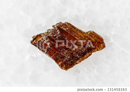 sample of rough rutile mineral on white marble 131458163