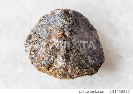 sample of raw brown titanite mineral on white 131458223