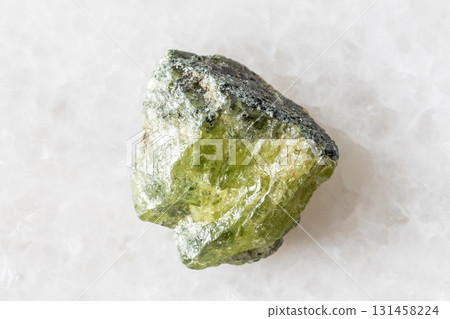 sample of raw green sphene mineral on white marble sample of raw green sphene mineral on white marble 131458224