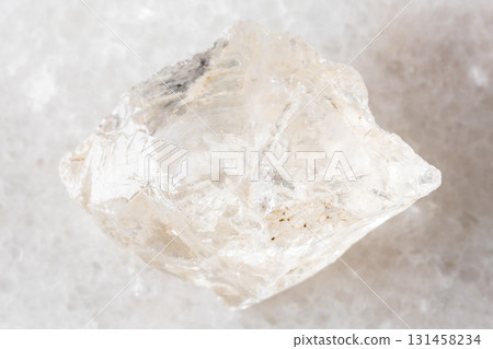 sample of raw rock crystal mineral on white marble sample of raw rock crystal mineral on white marble 131458234