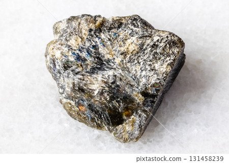 raw dark green labradorite mineral on white marble raw dark green labradorite mineral on white marble 131458239
