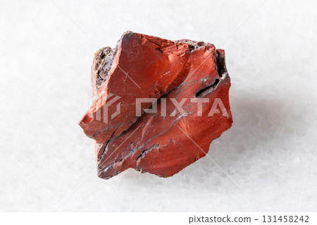 sample of raw red mookaite mineral on white 131458242