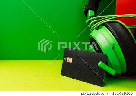 Black contactless bank card on green background for Black Friday and Cyber Monday shopping 131459100