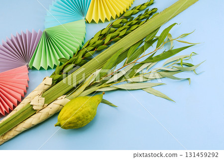 Jewish festival of Sukkot. Traditional symbols Etrog and Lulav on blue Jewish festival of Sukkot. Traditional symbols Etrog and Lulav on blue 131459292
