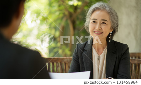 Senior women receive document consultation outdoors 131459964