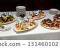 Elegant buffet table with assorted cheese, bruschetta and fresh fruits 131460102