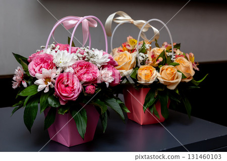 Floral gift arrangements in pink and peach decorative boxes 131460103