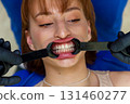 Young woman at dental checkup showing teeth with cheek 131460277