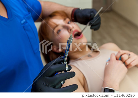 Dentist holding anesthesia syringe before dental procedure 131460280