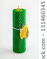 Natural wax candles with bay leaf and dried orange for rituals and space cleansing 131460345