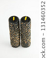 Decorative handmade candles with textured exterior and yellow wicks 131460352