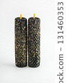 Unique black candles with textured surface and yellow wicks for home decor or rituals 131460353